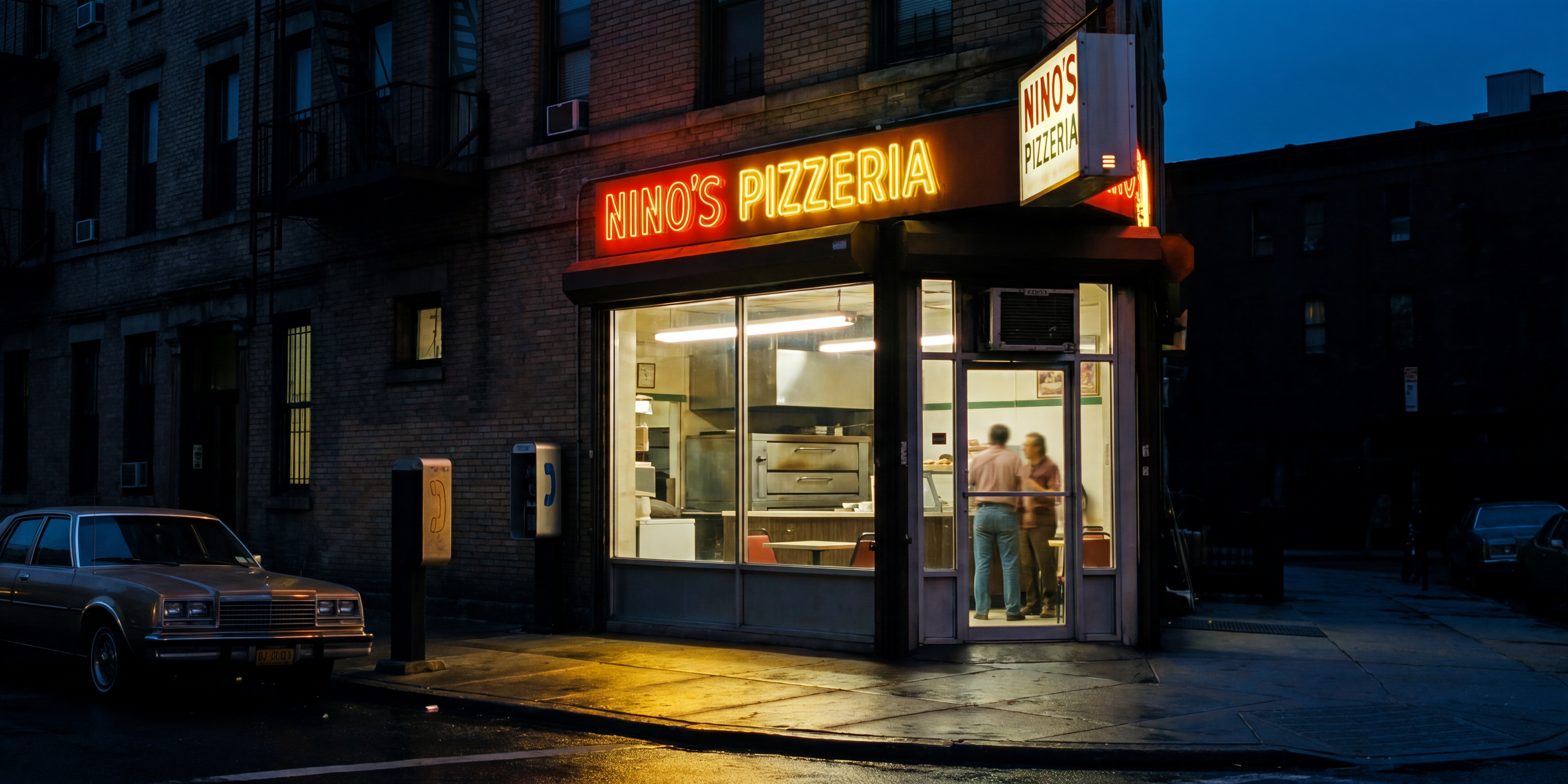 A corner pizzeria glowing warm at dusk on a 1980s Brooklyn street, a few people passing on the wet sidewalk and period sedans parked at the curb.